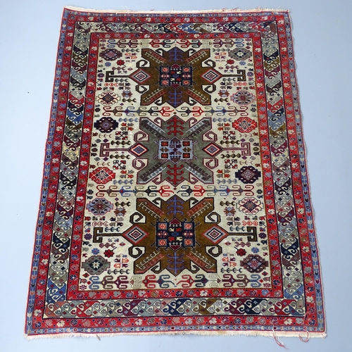 2255 - A red and cream-ground Caucasian rug. 175x130cm