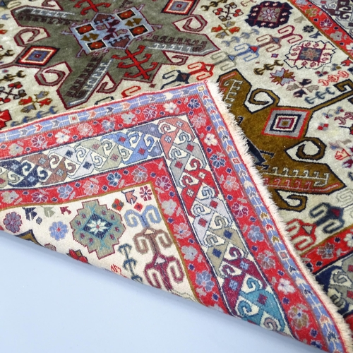 2255 - A red and cream-ground Caucasian rug. 175x130cm