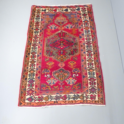 2256 - A red-ground Afghan rug. 204x130cm