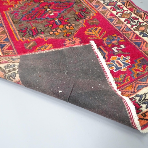 2256 - A red-ground Afghan rug. 204x130cm