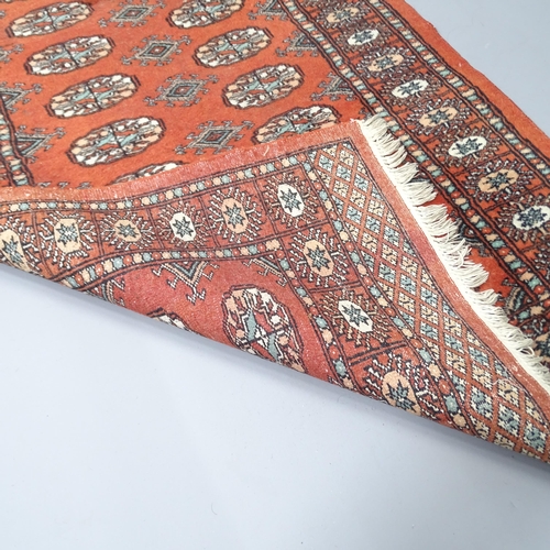 2258 - An orange-ground Afghan runner. 245x83cm