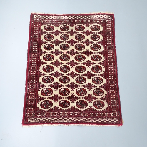 2259 - A red and white-ground Afghan rug. 145x117cm