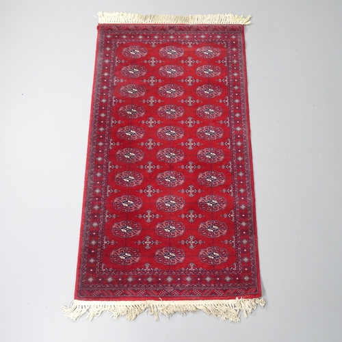 2260 - A Belgian made modern red-ground machine made Afghan design wool runner. 157x85cm.