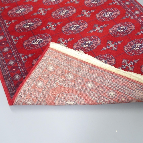 2260 - A Belgian made modern red-ground machine made Afghan design wool runner. 157x85cm.