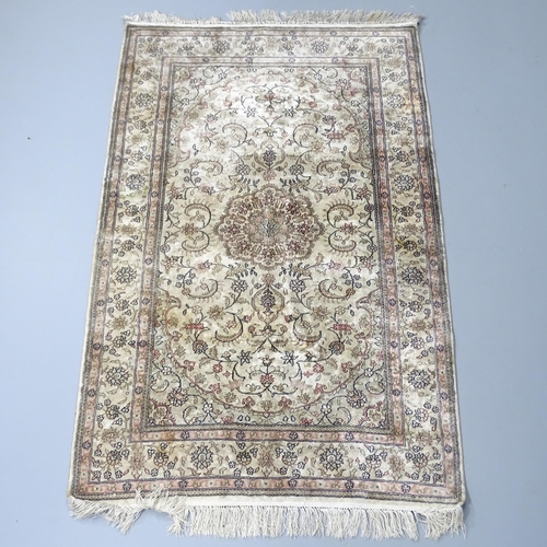 2261 - A cream-ground Persian silk rug. 150x94cm