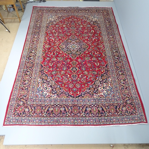 2282 - A red ground Tabriz carpet. 315x218cm