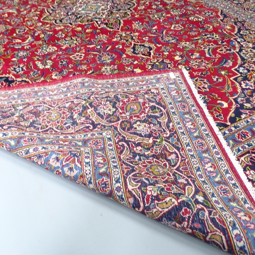 2282 - A red ground Tabriz carpet. 315x218cm