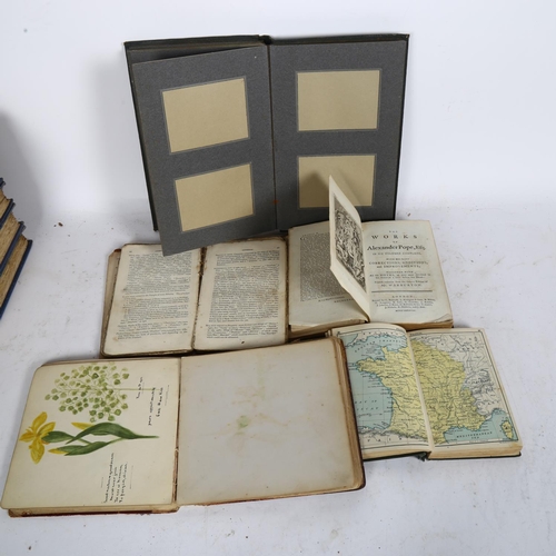 602 - An autograph album with watercolours and sketches, an empty photograph album, and a pocket atlas etc