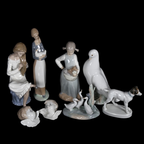 623 - A group of porcelain figures, including a NAO dove, H20cm, Lladro angels etc