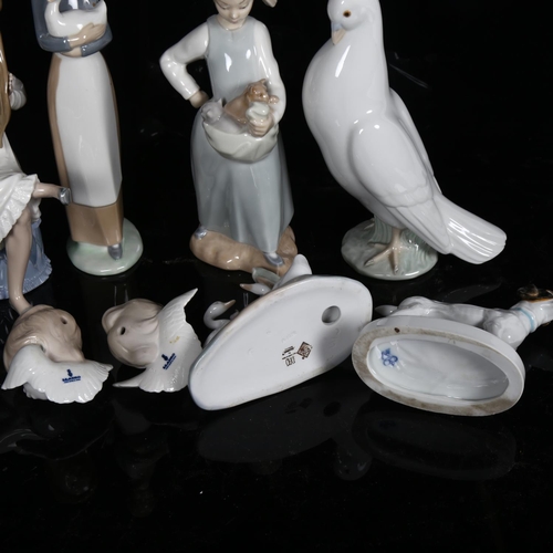 623 - A group of porcelain figures, including a NAO dove, H20cm, Lladro angels etc