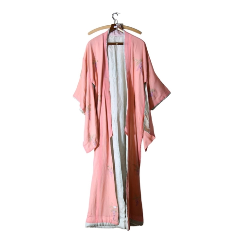 628 - An early 20th century Japanese pink silk Kimono, with embroidered floral decoration, lined