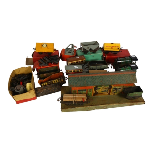 632 - A quantity of Vintage Hornby trains and accessories, including tin station diorama, and O gauge ceme... 