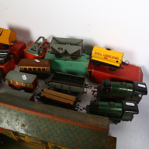 632 - A quantity of Vintage Hornby trains and accessories, including tin station diorama, and O gauge ceme... 