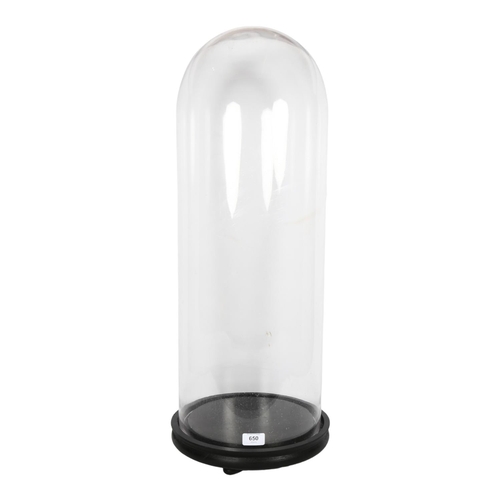 650 - A large modern glass dome on wooden base, height including base 76cm