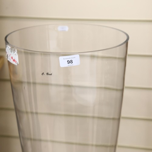 98 - A large floor standing clear glass vase of waisted form, H120cm