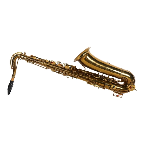 690 - A brass tenor saxophone by Dore of Paris, cased