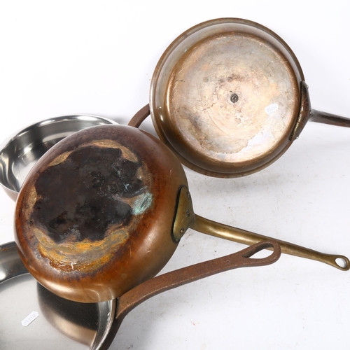 711 - A set of 3 polished copper pans with iron handles, largest 30cm diameter, and a copper pan with bras... 