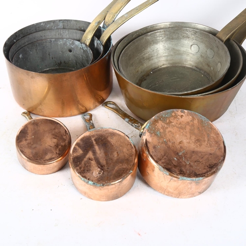 712 - A graduated set of 3 copper pans with brass handles, largest 20cm diameter, and a set of 6 copper pa... 