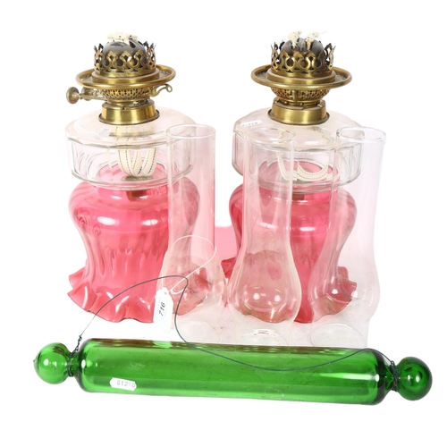 716 - A pair of Antique oil lamp shades and fonts, lacking bases, 3 chimneys and a green glass rolling pin