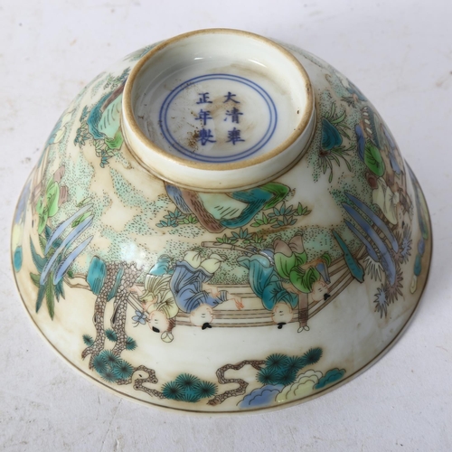 723 - A Chinese famille verte bowl on foot, with painted village figure decoration, and a blue six charact... 