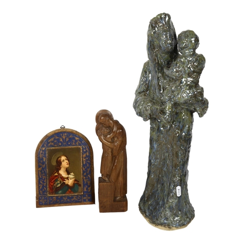 742 - A carved wood sculpture of St Joseph, H27cm, a glazed Studio pottery Madonna and child, and a religi... 