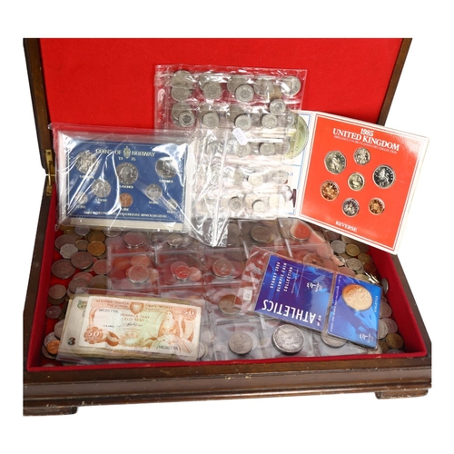 783 - A boxful of world coins, including commemorative items and various banknotes