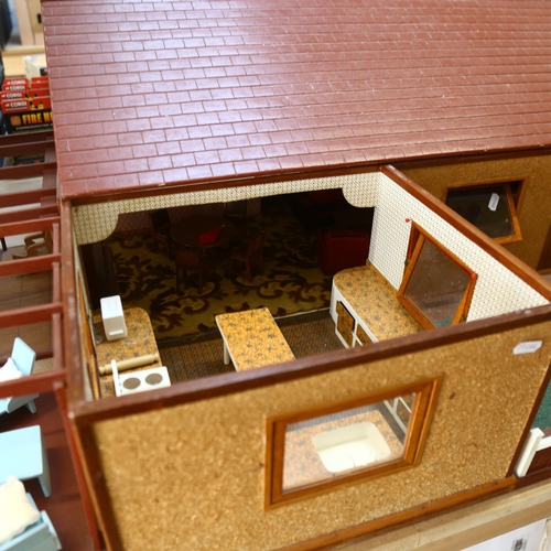 552 - A modern bungalow doll's house made in the 1980s, with fitted interior, and some furniture, H38cm, L... 