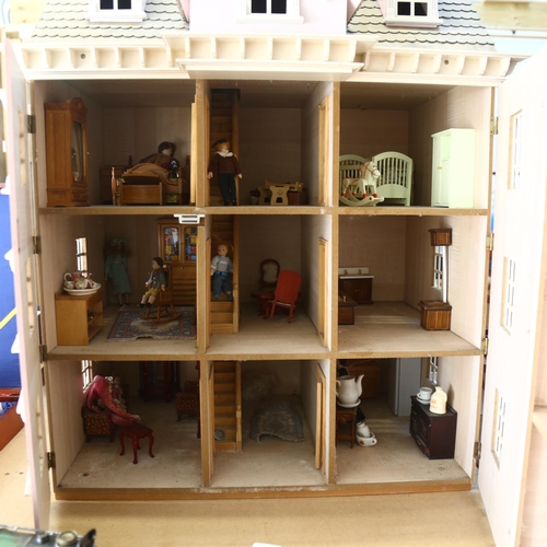 553 - A modern handmade townhouse doll's house, with fitted interior over 3 floors and a loft, with associ... 