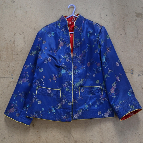 567 - An Oriental embroidered blue ground jacket, and a red silk housecoat