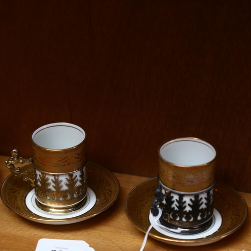 586 - A set of 5 Limoges coffee cans and saucers, in pierced silver holders, and an extra holder