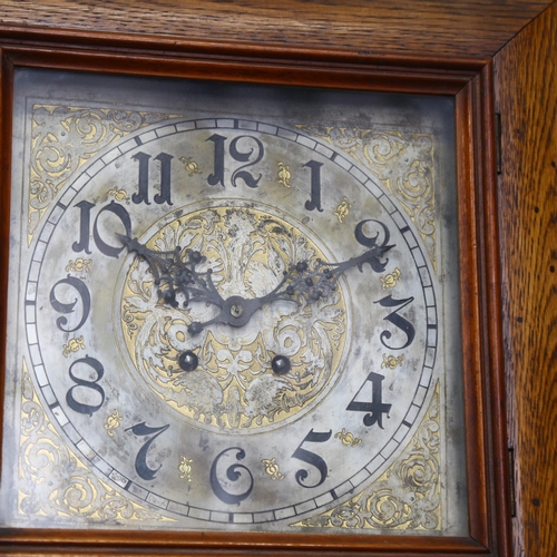 606 - A square oak-cased 2-train wall clock, with engraved dial, 37cm