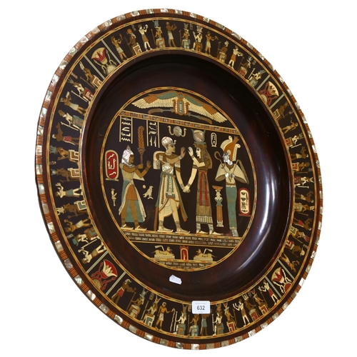 632 - An Egyptian painted and inlaid wall plaque/charger with figure decoration, 61cm