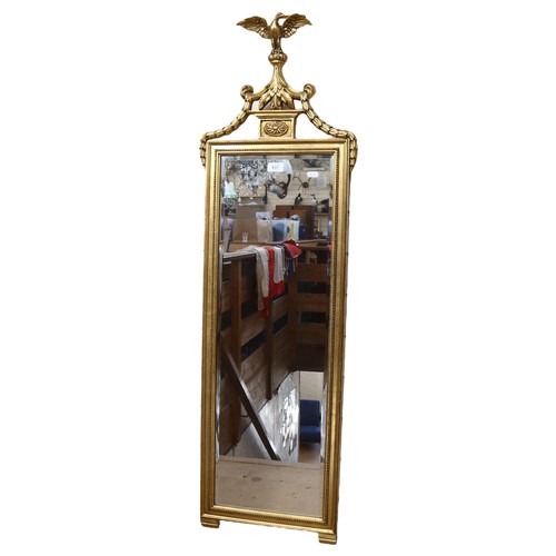 637 - Antique style gilt-framed bevel-edge wall mirror, surmounted by an eagle, 203cm