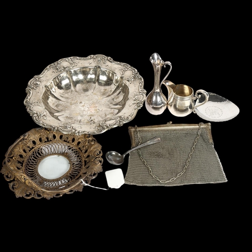 910 - A silver plated table bowl with embossed decoration, a swing-handle basket with scrolled and pierced... 