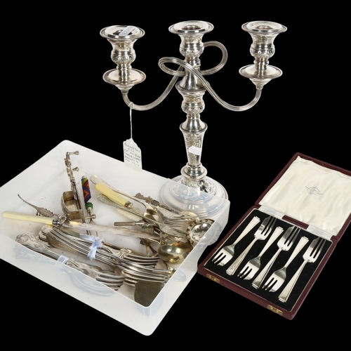 911 - An Elkington & Company silver plate on copper candelabra, various cutlery and candle snuffers