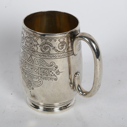 1005 - A Victorian silver christening mug, having allover engraved decoration and named to William Dennis R... 