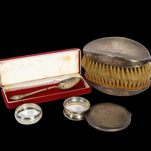 1010 - A pair of engine turned silver-backed clothes brushes, 2 silver napkins, a compact and a James II re... 