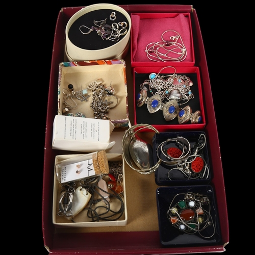 982 - A tray of silver costume jewellery, including a lapis set oval panel bracelet, various earrings, nec... 