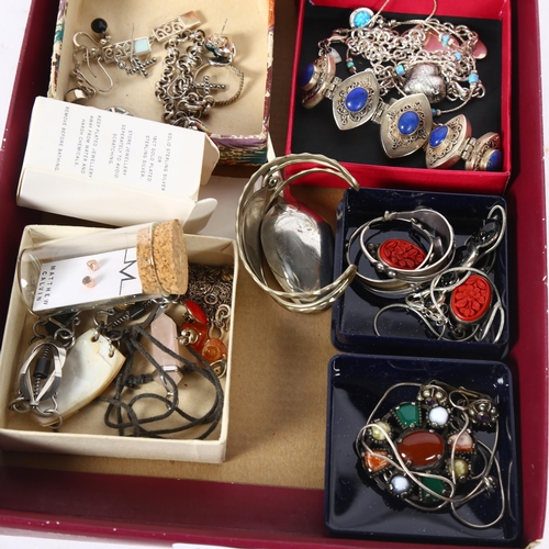 982 - A tray of silver costume jewellery, including a lapis set oval panel bracelet, various earrings, nec... 