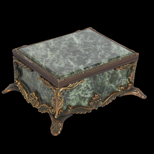 993 - A green hardstone keepsake box, with gilt-metal mounts, red velvet lining