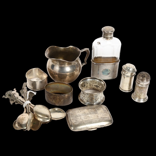 995 - A group of silver ware to include a cream jug, 3 napkin rings, silver cigarette box, silver-mounted ... 