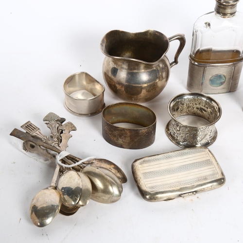 995 - A group of silver ware to include a cream jug, 3 napkin rings, silver cigarette box, silver-mounted ... 