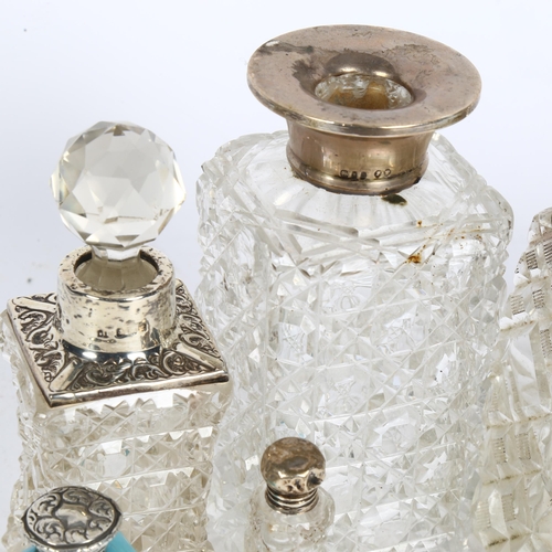 998 - A pair of cut-glass and silver-mounted scent bottles, and 5 other silver-mounted toilet bottles