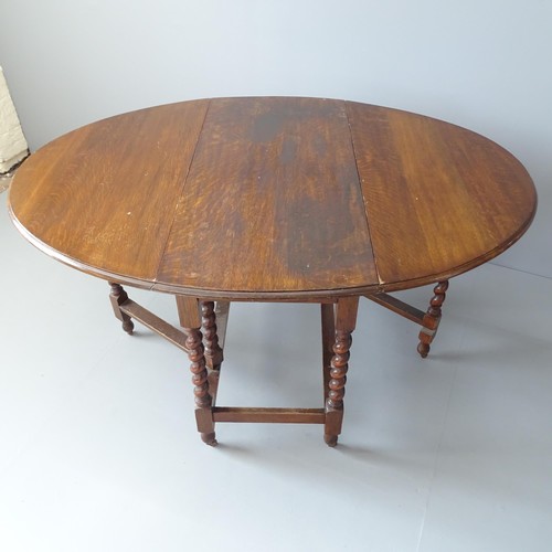 2243 - An antique oak oval barley twist gate-leg table. 108x77x52cm (extending to 146cm).