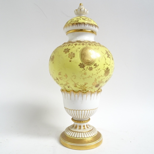 555 - Antique Minton's porcelain vase and cover, with gilded decoration on yellow ground, H28cm