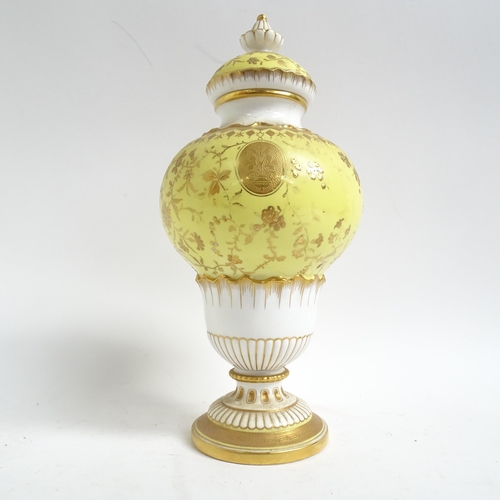 555 - Antique Minton's porcelain vase and cover, with gilded decoration on yellow ground, H28cm