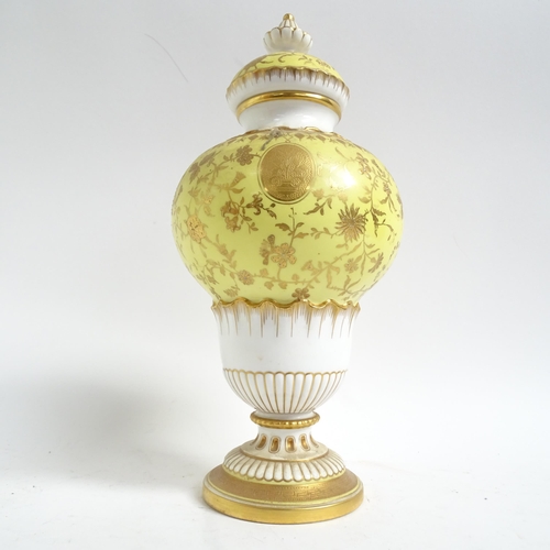 555 - Antique Minton's porcelain vase and cover, with gilded decoration on yellow ground, H28cm