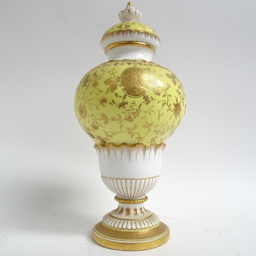 555 - Antique Minton's porcelain vase and cover, with gilded decoration on yellow ground, H28cm