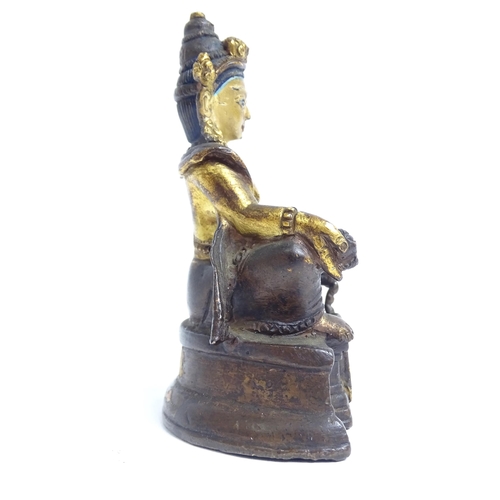 135 - A small Tibetan patinated bronze Jambhala, H9cm