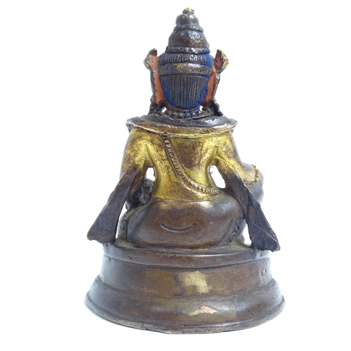 135 - A small Tibetan patinated bronze Jambhala, H9cm